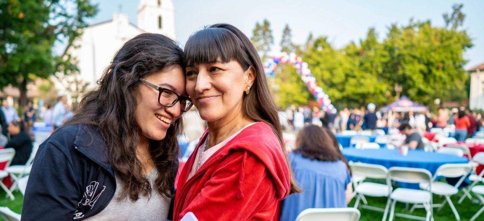 A parent and student hugging at the farewell bbq